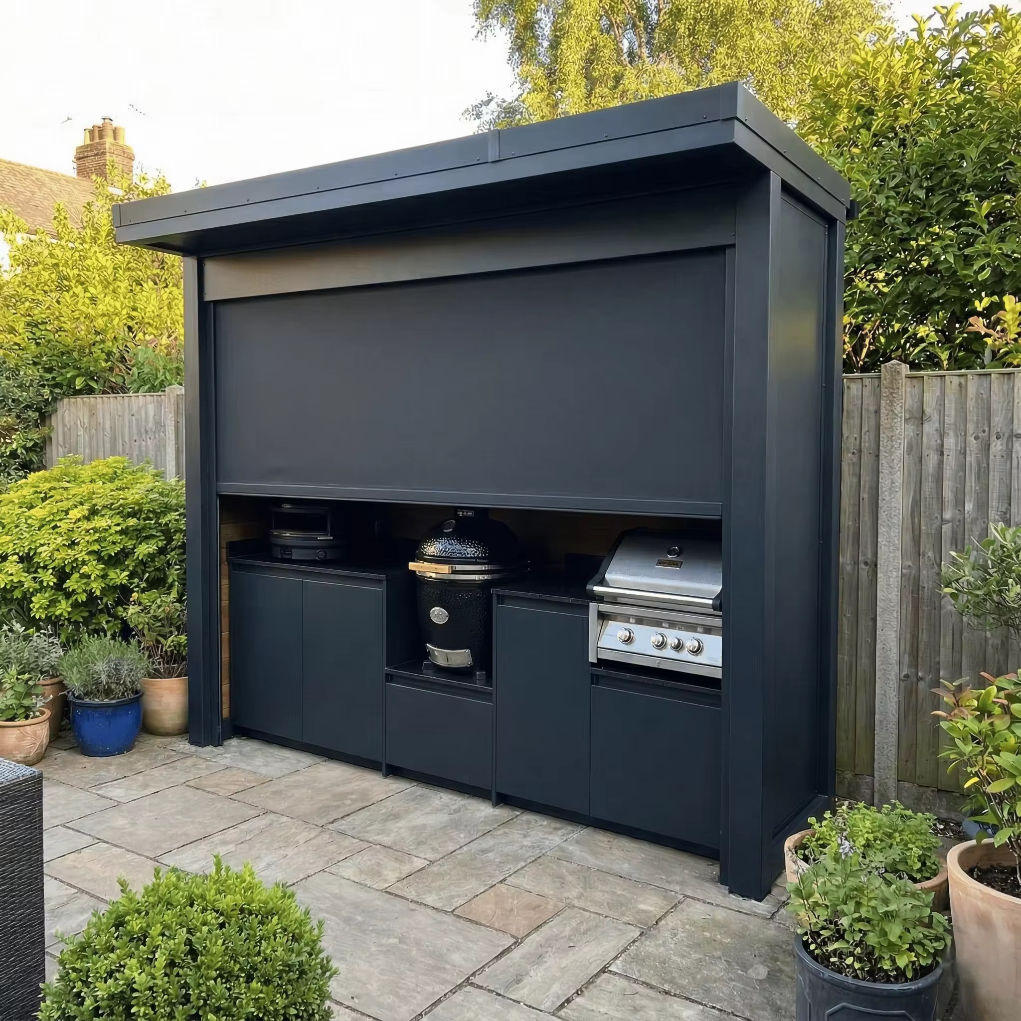 Automatic roll-up outdoor kitchen with front shutter in garden setting