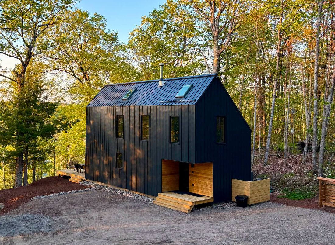 Dark cabin among pines