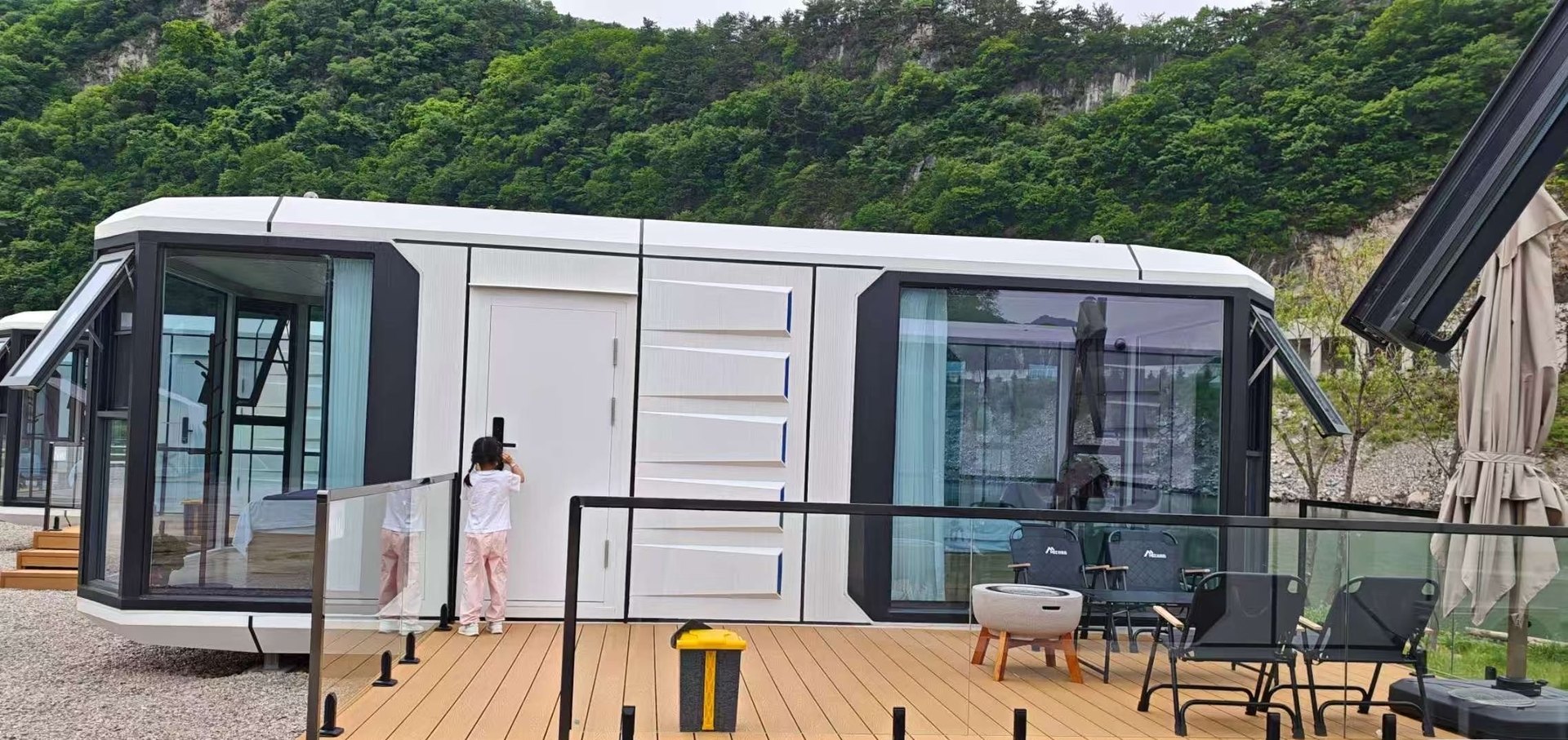 Guests at a capsule lakeside deck