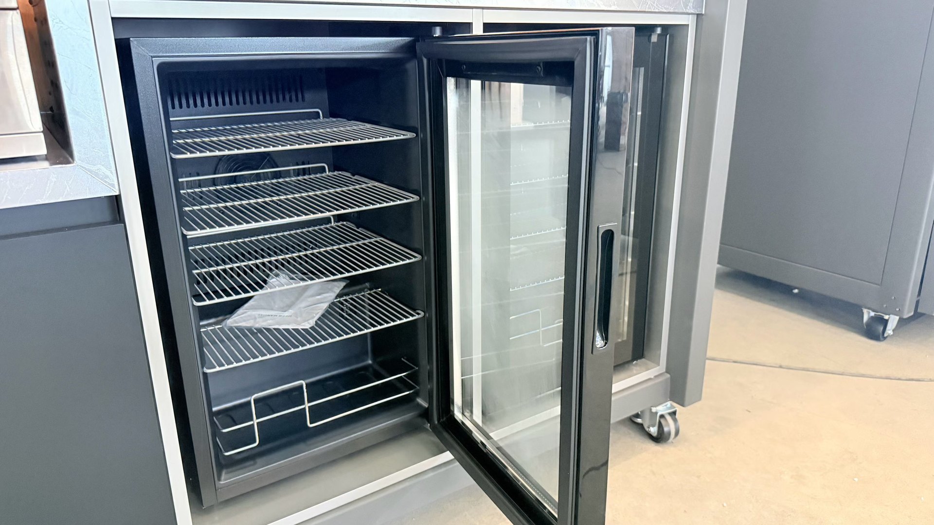 Built-in bar fridge and appliance bay of the outdoor kitchen
